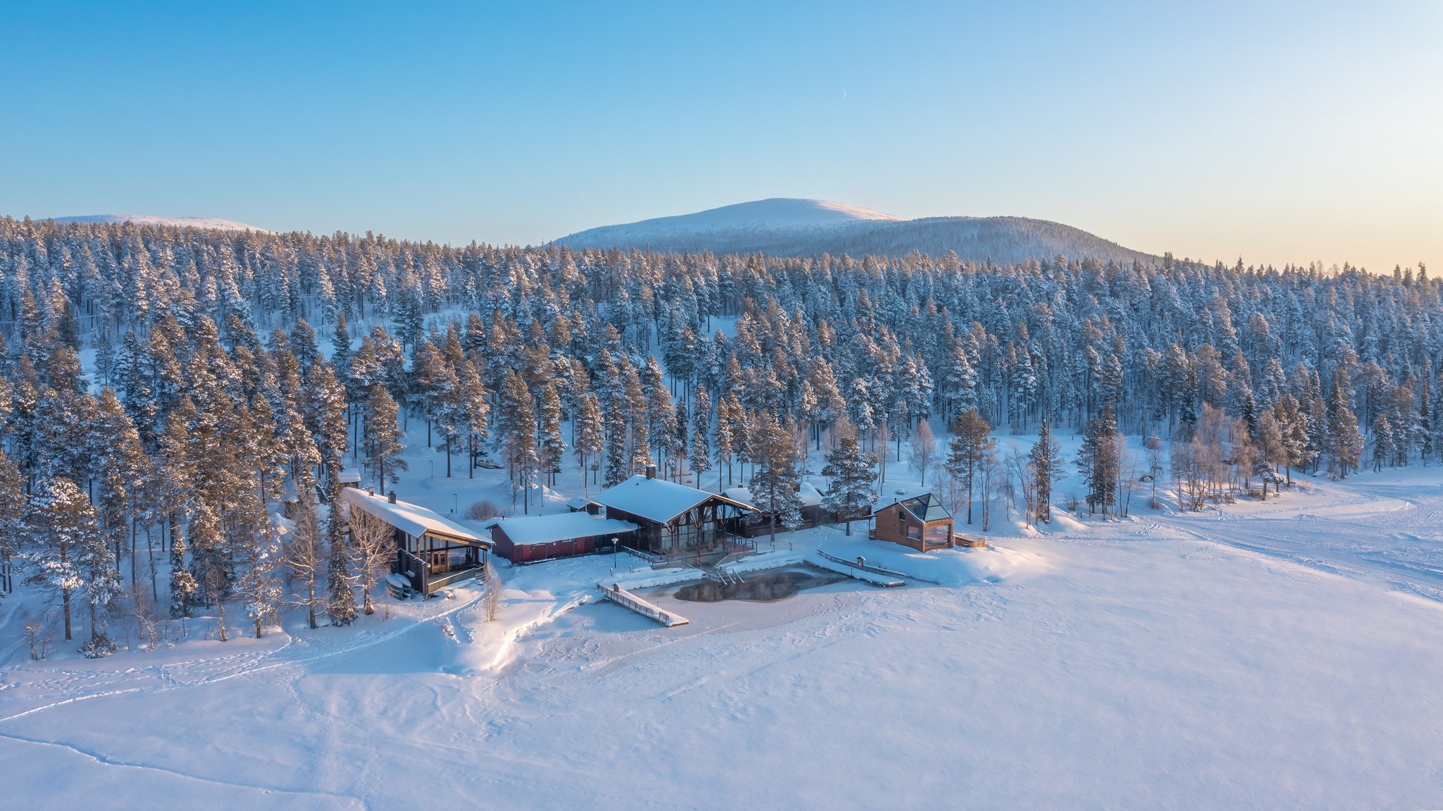 Aerial view of Arctic Sauna World with Pallas-Ylläs national park at the back in Muonio, Lapland, Finland